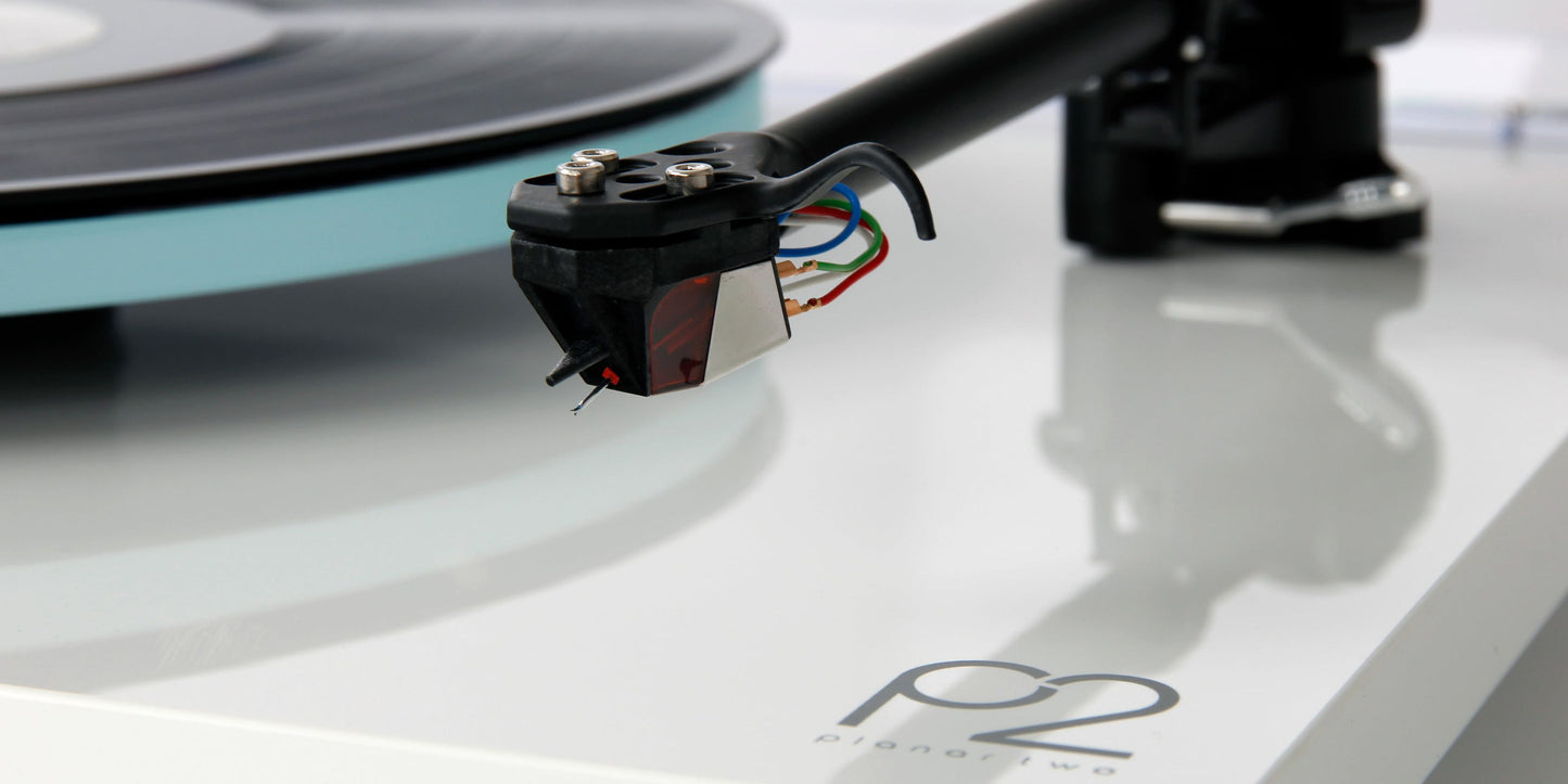 A closeup on a white Rega Planar 2 With Nd3 Cartridge