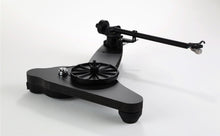 Black Rega Replay turntable with a minimalist plinth, platter, and extended tonearm for home audio systems.