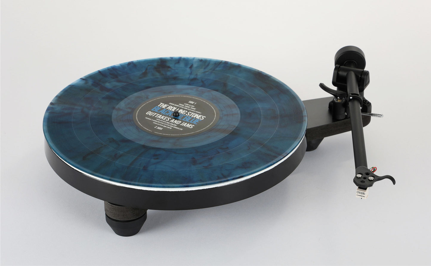 Rega Replay turntable with a blue marbled platter, black tonearm, and low-profile base for home audio systems.