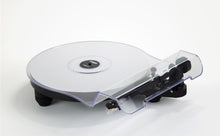 Rega Replay turntable with a clear acrylic dust cover, black platter and compact black base.