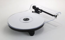Rega Replay turntable with a white platter, black base, and sleek tonearm with cartridge.