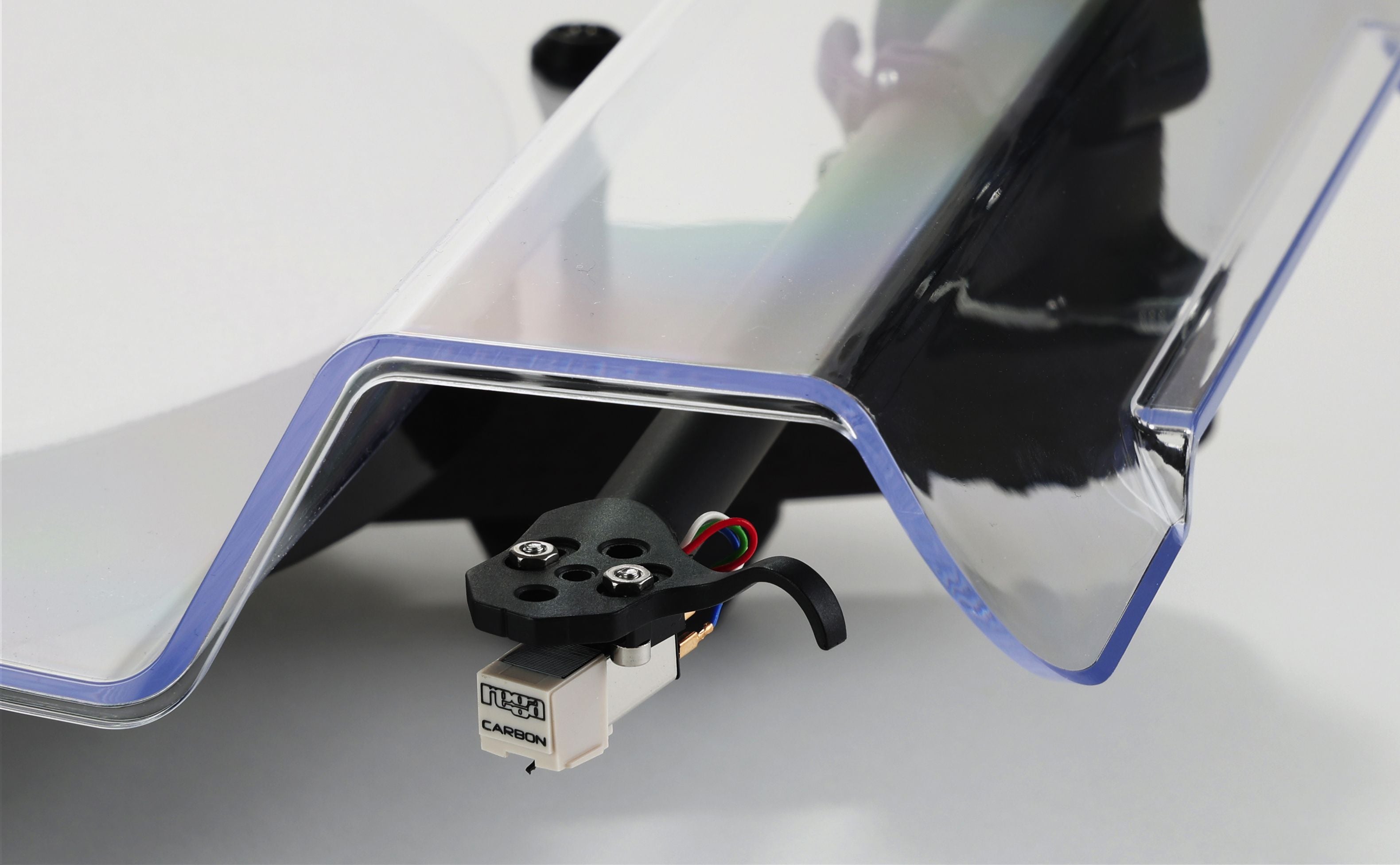 Rega turntable beneath a clear dust cover, with a black cartridge and tonearm visible.
