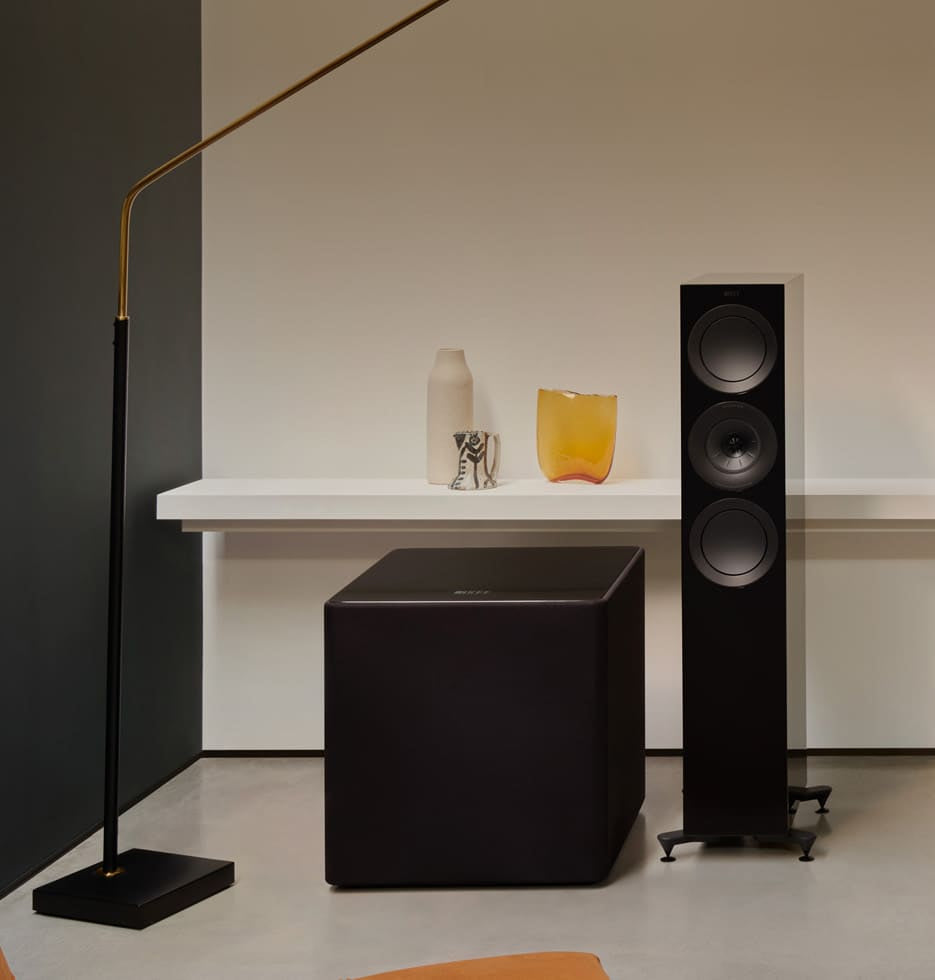 Home theater system with KEF KUBE 15 MIE 15" Subwoofer and a TV in a living room setting.