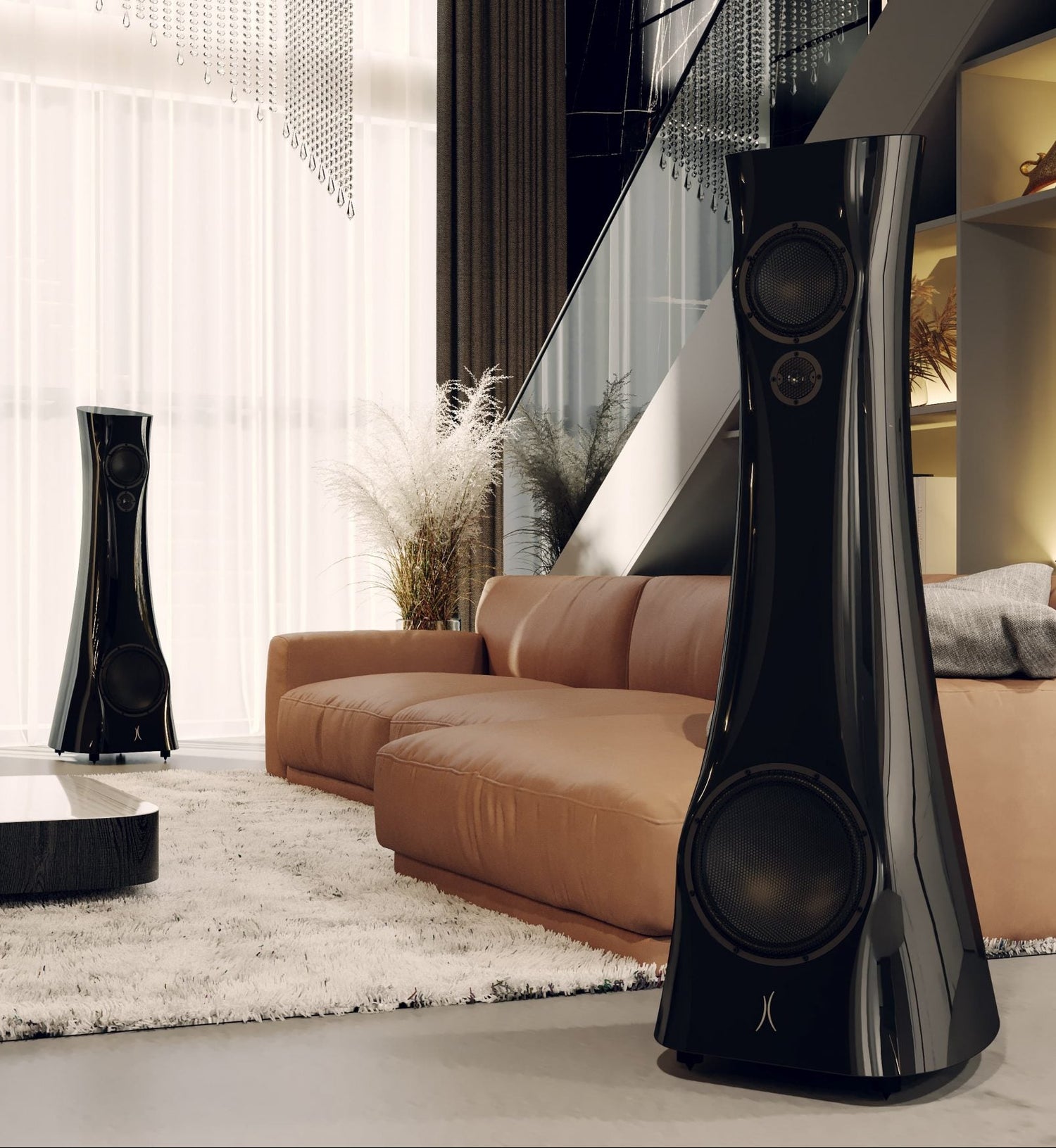 Modern living room with a stylish sofa, coffee table, and two tall black Estelon X Diamond MK II Reference Speaker
 speakers.