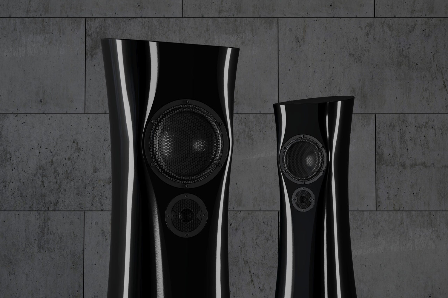 A closeup of a pair of Black Lava Liquid Gloss Estelon XB MK II reference speakers with a curved-sculptural design, standing in an industrial environment.