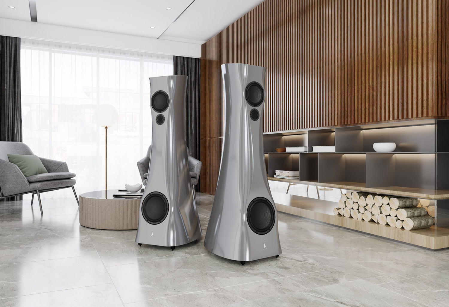 A pair of Silver Pure Alu Liquid Gloss Estelon XB MK II reference speakers with a curved-sculptural design, standing in a modern living room.