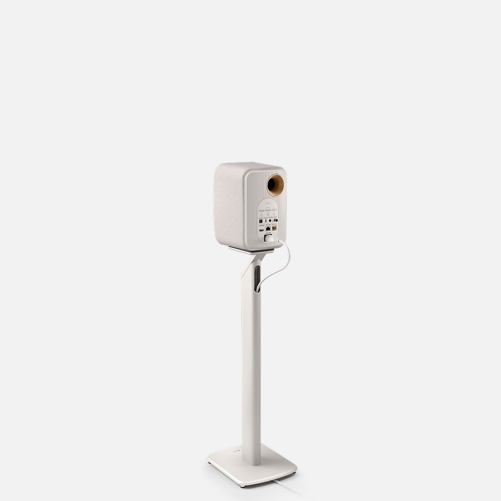A back side of a white KEF speaker on a KEF S1 Floor Stands for LSX II against a white background