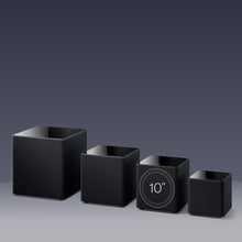 A llineup of different sizes of KEF KUBE MIE Subwoofers.