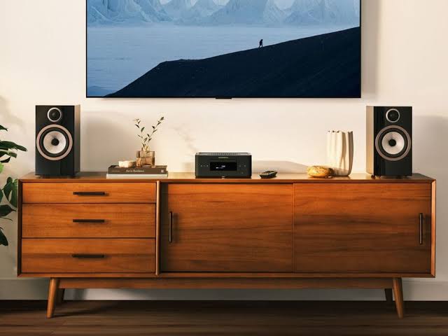 Marantz MCR 60n compact hi-fi system centred on a mid-century modern credenza flanked by two bookshelf speakers below a wall-mounted TV