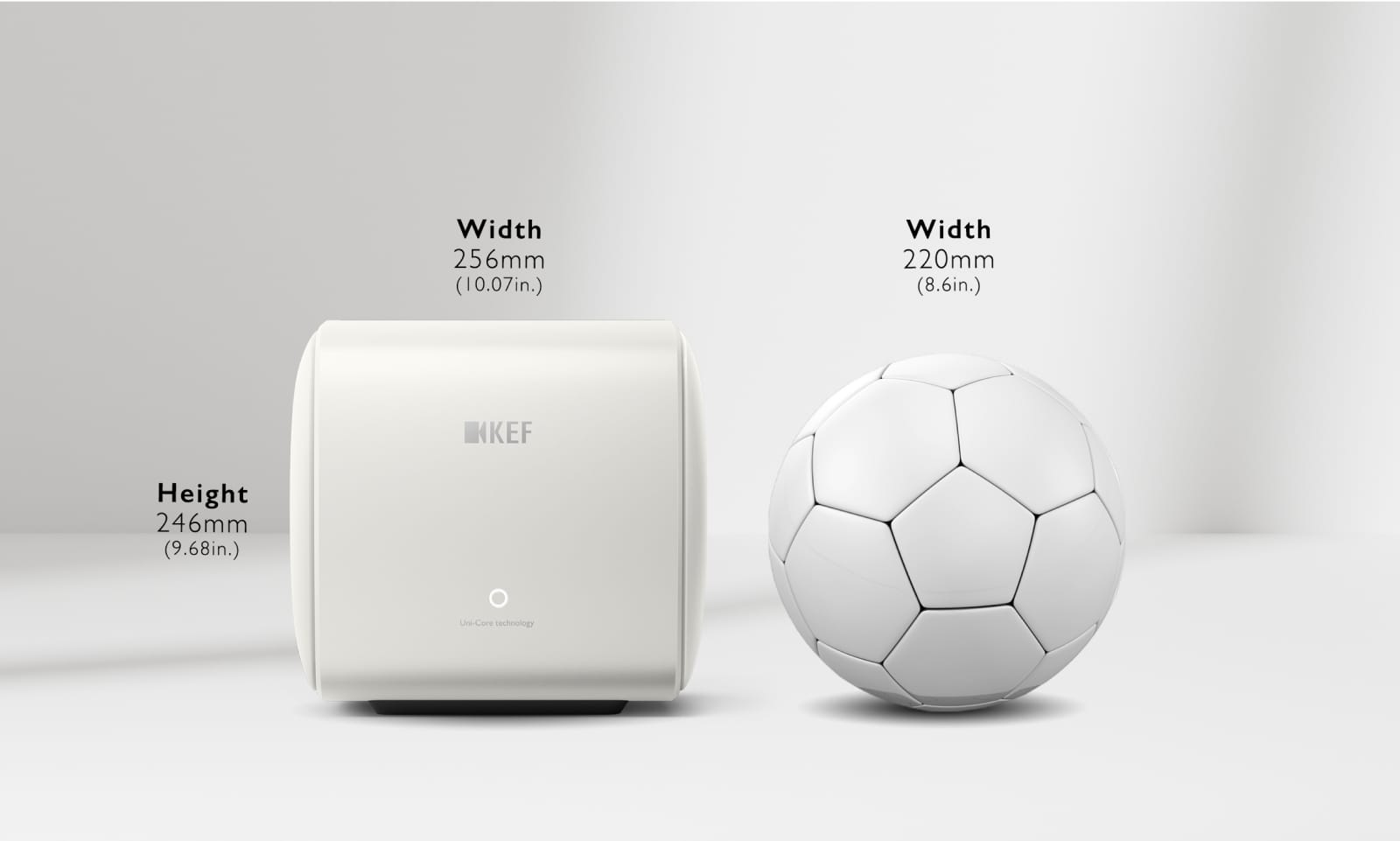 White KEF KC62 Subwoofer with dimensions labeled next to a soccer ball on a light gray background