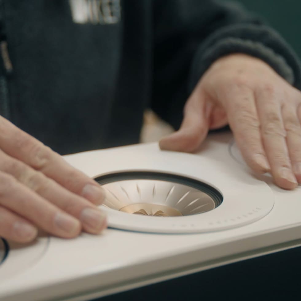 Close-up of hands crafting KEF Ci3160REFM-THX Reference In-Wall
speaker.