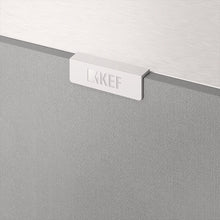 A closeup on a KEF Logo on a white KEF Q4 Meta On-Wall Speaker.