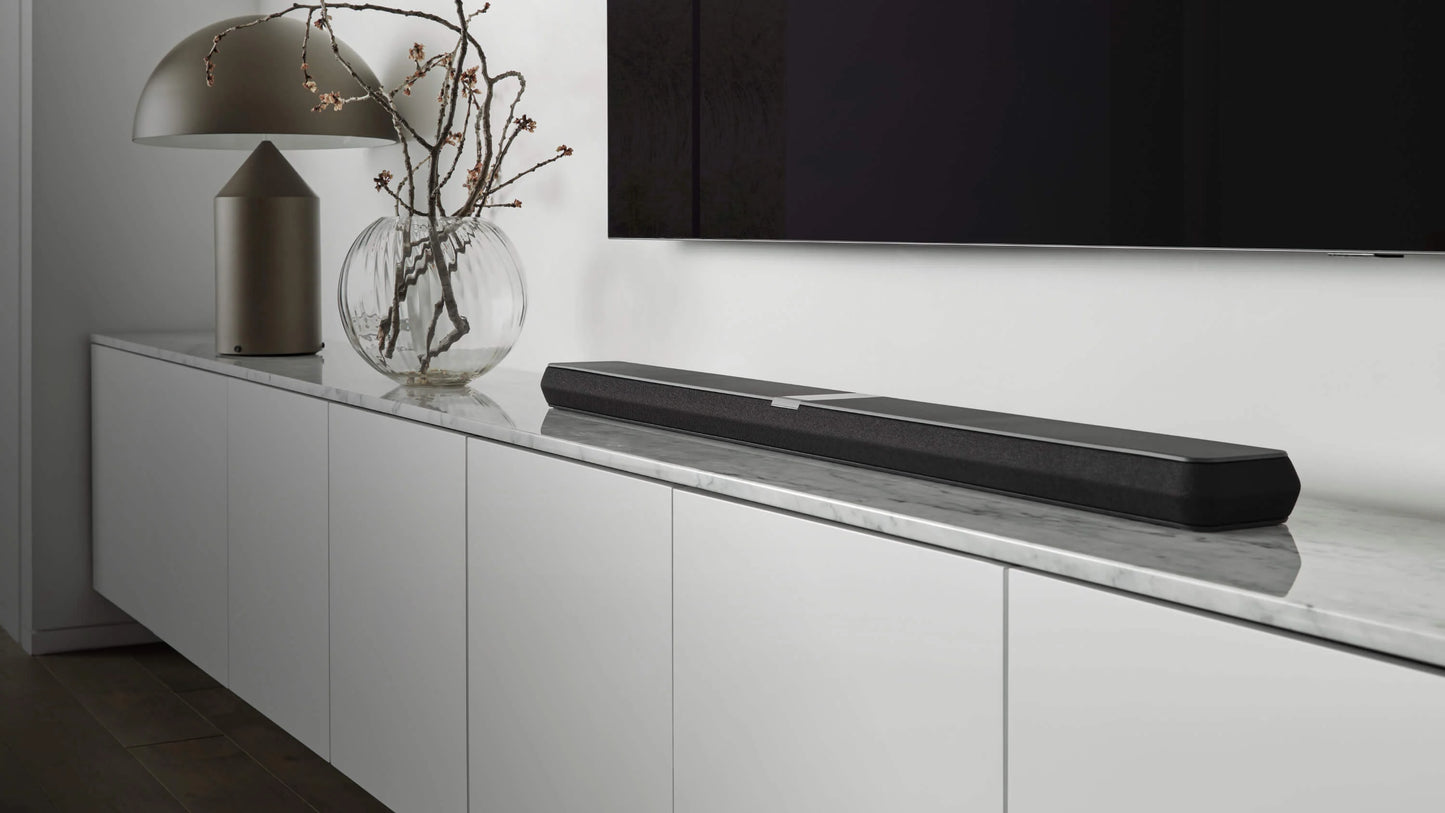 B&W Panorama 3 Sound bar on a white entertainment console with a TV in the background - Hi-Fi Centre.