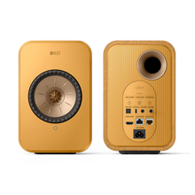 Yellow KEF LSX II speakers on a white background