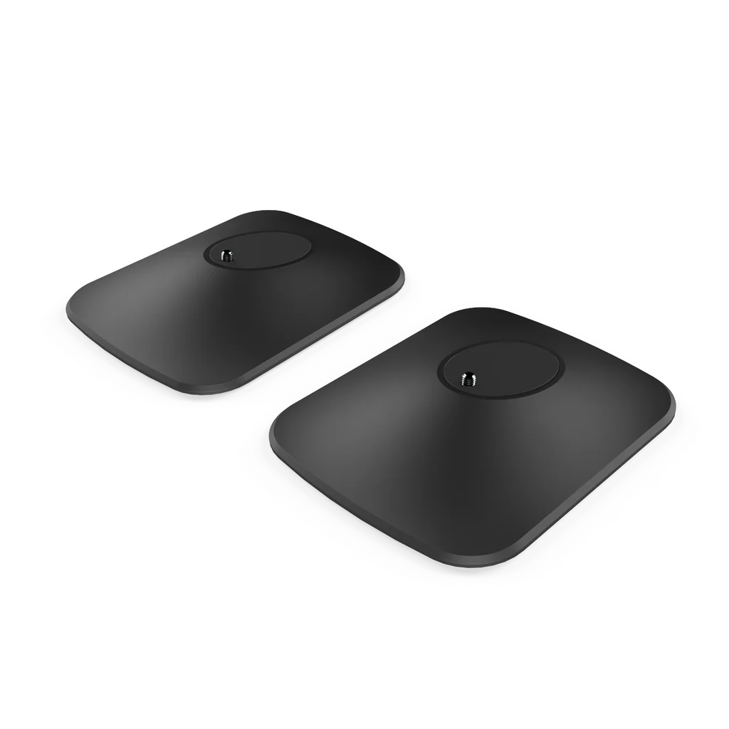 Two black, circular desk stands for KEF LSX II speakers, displayed against a white background.
