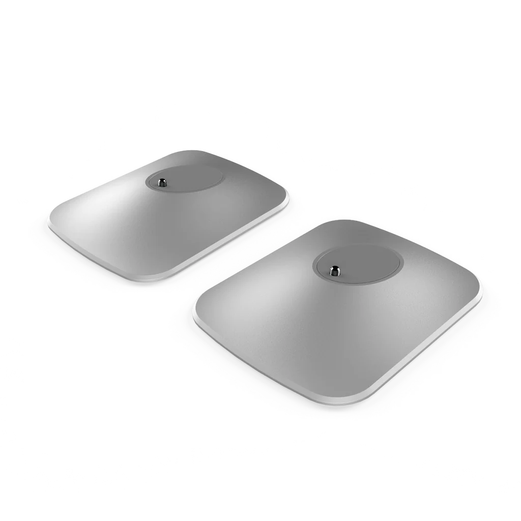 Two black, circular desk stands for KEF LSX II speakers, displayed against a white background.