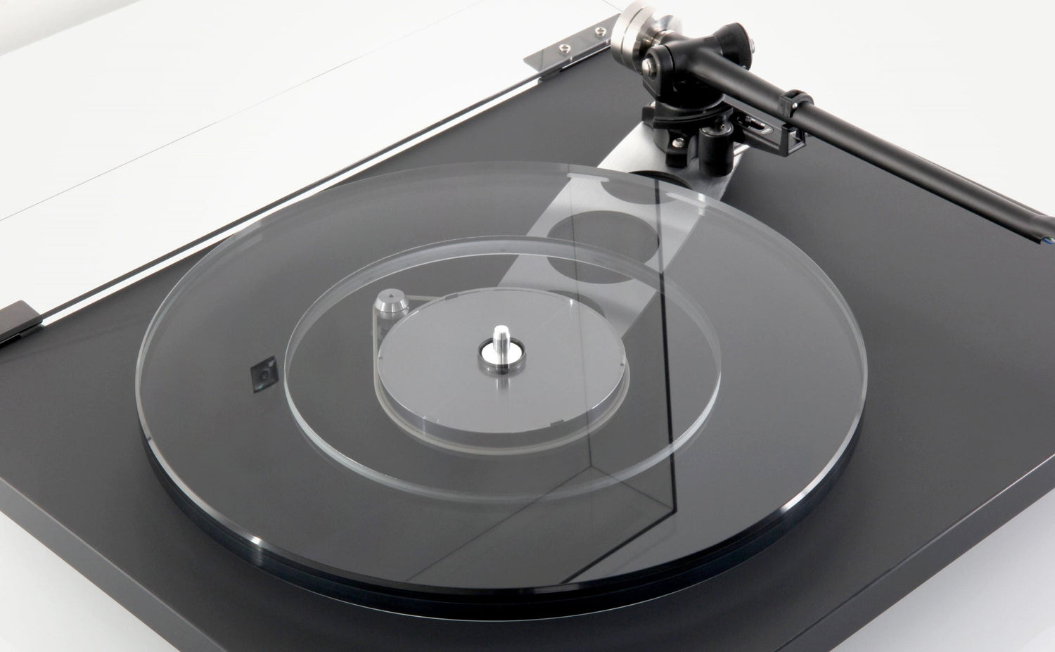 Black Rega Planar 6 turntable with clear platter and tonearm, no cartridge installed.