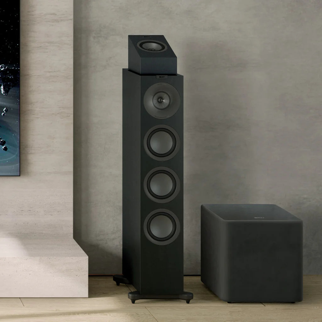 Black floor-standing KEF Q8 Meta Atmos speakers and subwoofer against a gray wall.