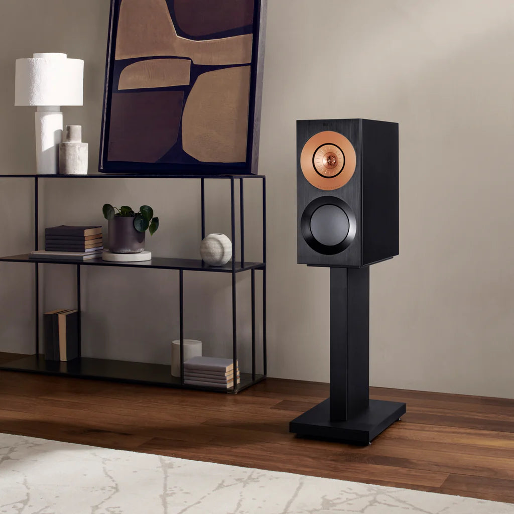 Black floor-standing KEF Reference 1 Meta speaker in a room with decor elements.