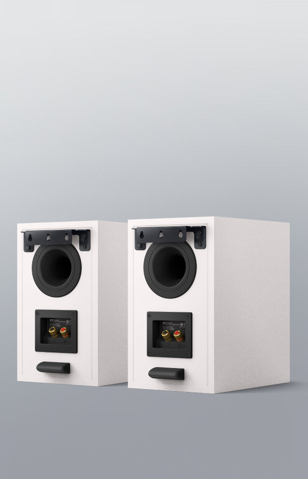 The back side of a pair of white KEF Q3 Meta Bookshelf Speakers.