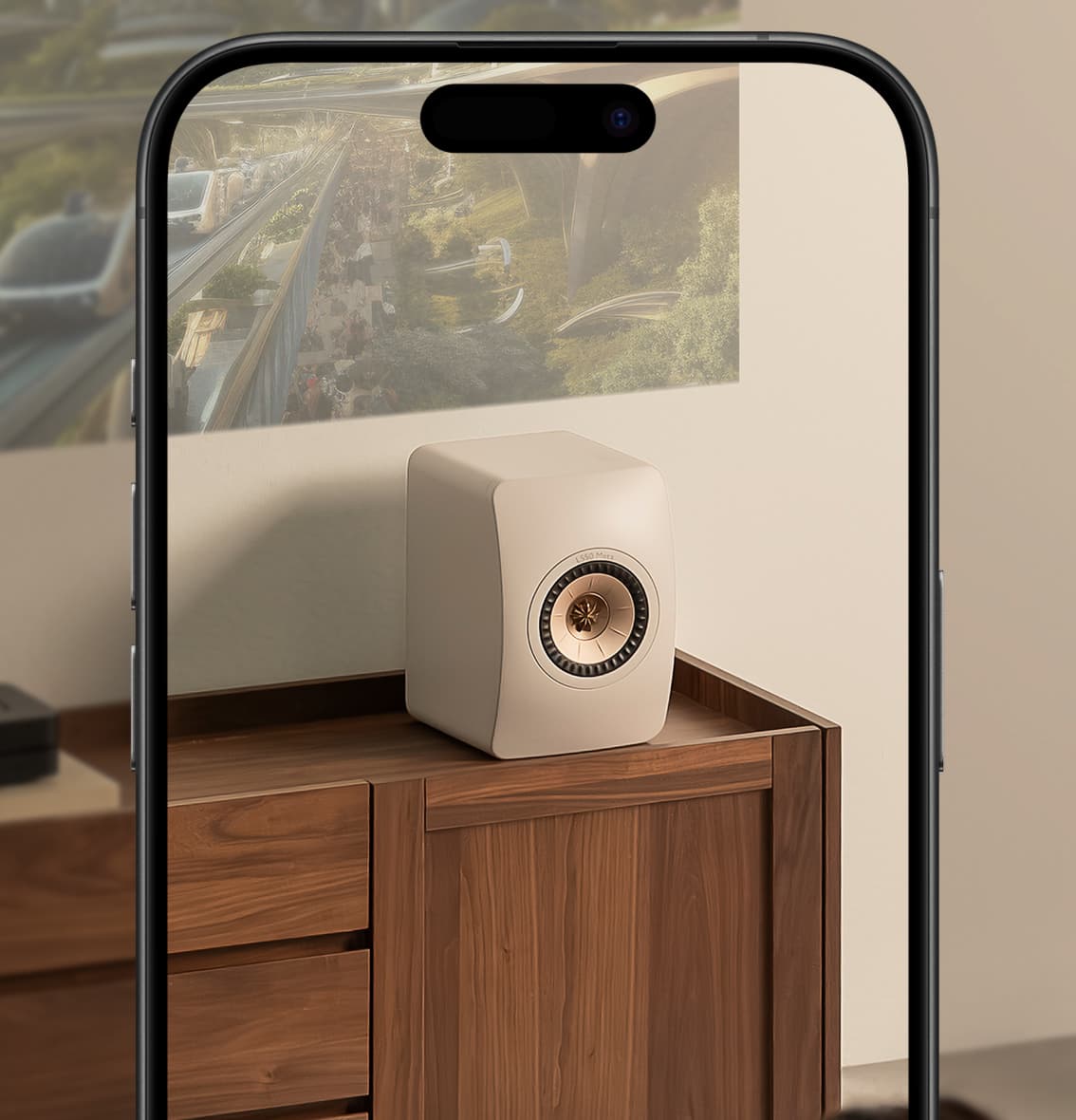 White KEF LS50META Bookshellf Monitor
speaker on a wooden cabinet with a phone screen showing a cityscape.