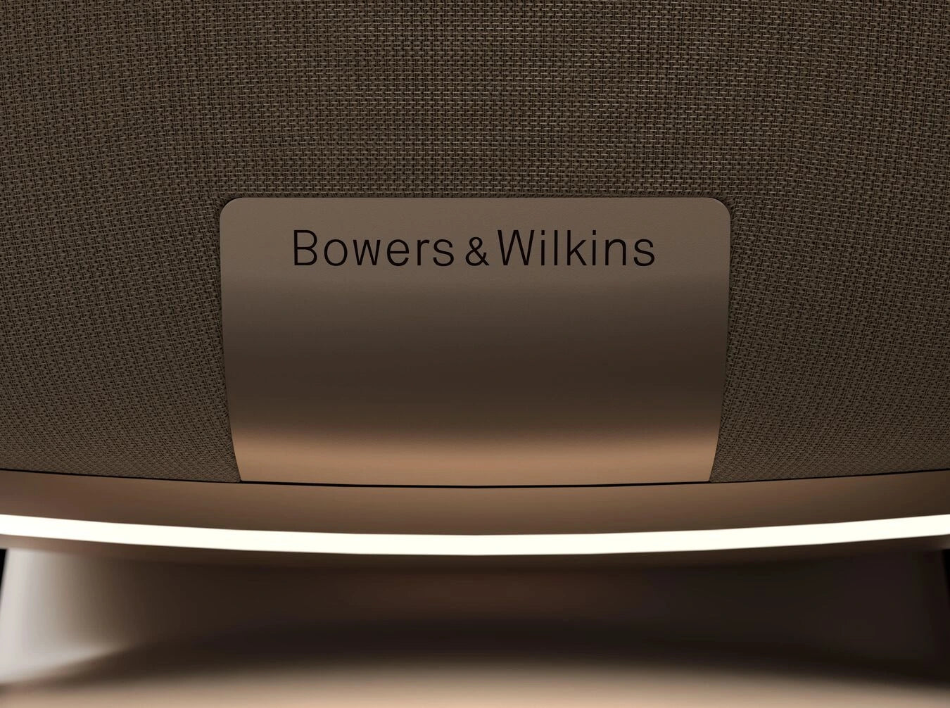 A closeup on a logo of a Bowers & Wilkins Zeppelin Pro Wireless Speaker in solar gold.