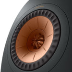 A closeup on A pair of KEF LS50META black bookshelf speaker's copper dome tweeter.