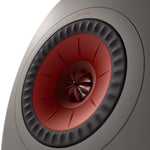 A closeup on A pair of KEF LS50META grey bookshelf speaker's copper dome tweeter.