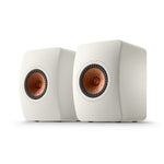 A pair of KEF LS50META bookshelf speakers with a mineral white finish and copper-colored tweeter baskets.