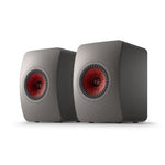 A pair of KEF LS50META titanium grey bookshelf speakers with a visible copper dome tweeter.
